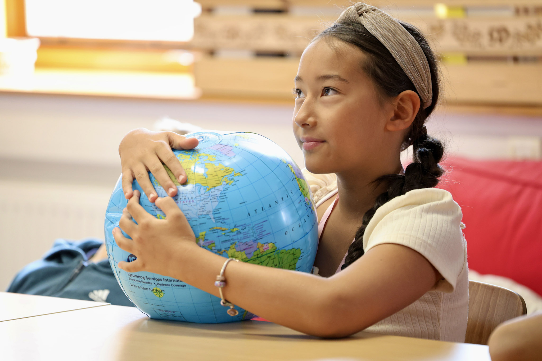 Girl hugging a globe